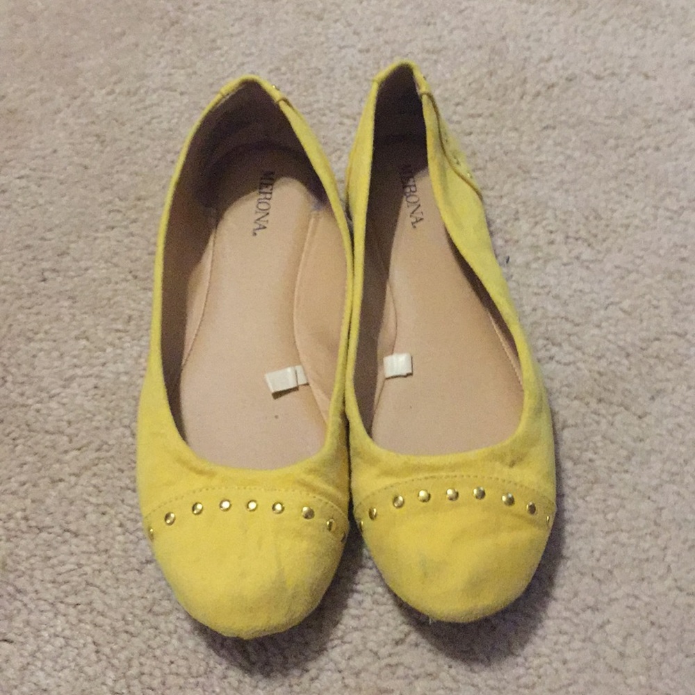 Mustard color flats with gold toe embellishment.